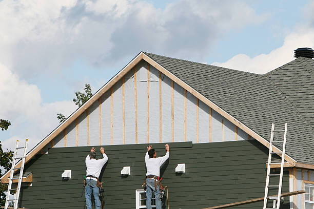 Professional Storm Damage Siding Repair technician working in Tipp City, OH